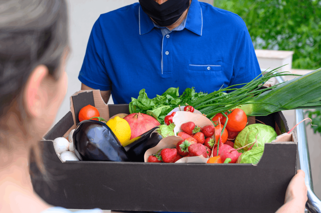 delivery-man-wearing-face-mask-holding-box-with-vegetables (1)